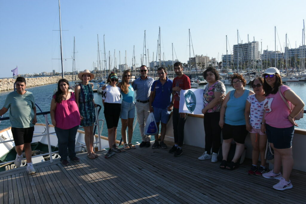 The participants are on a boat featuring Larnaca Marina